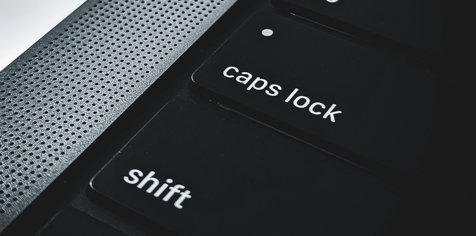 Apple MacBook keyboard close-up, shift and caps-lock